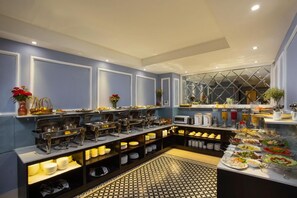 A buffet setup with various food stations and a patterned floor. - 22land 71 Hang Bong Hotel (Hanoi)