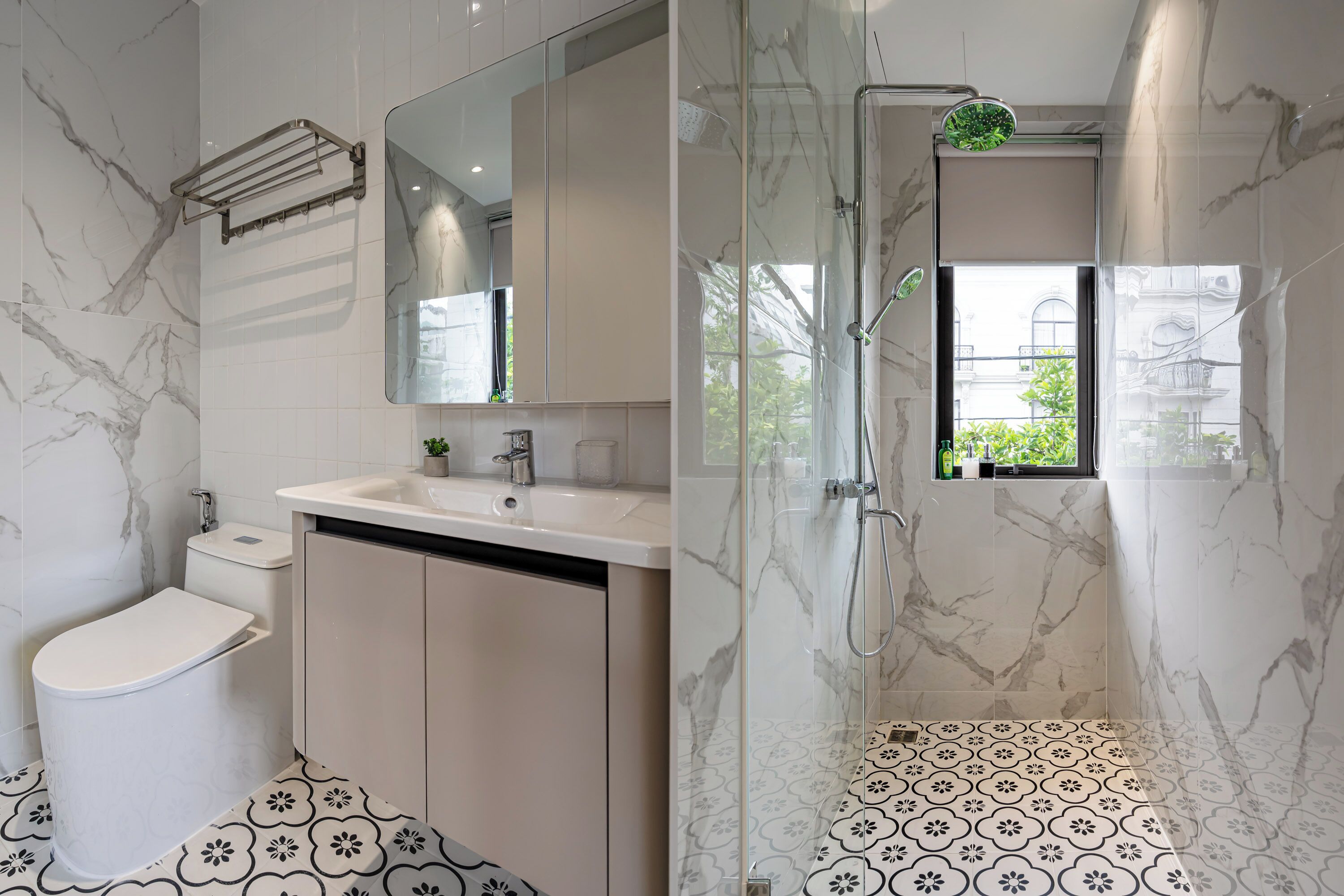 A bathroom with a toilet, sink, and shower area.