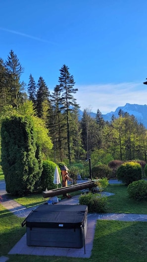 A serene outdoor area with a wooden deck, a small table, and a bench.