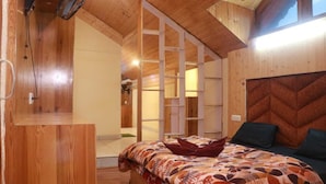 A wooden room with a bed, a wooden cabinet, and a large window. - Pirates Of Parvati (Bhuntar)