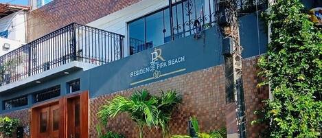A residential building with a sign reading 'Residence Pipa Beach.'
