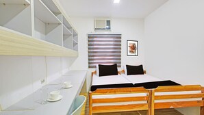 A room with a bunk bed, a desk with a chair, a small window, and a framed picture on the wall. - Collection O Metro Manila near University Belt formerly 1318 Residences (Manila)