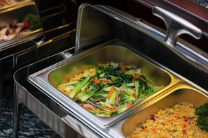 A buffet with various dishes including noodles, vegetables, and rice. - Serene Central hotel (Hanoi)