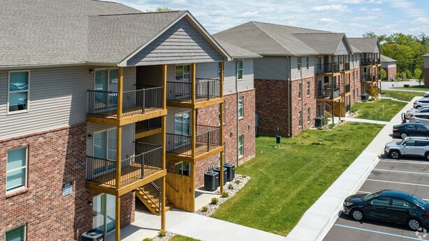A multi-story residential building with balconies and a parking lot. - Stonecrest 701, 2Bd Apt I Free Parking I Pool (New Albany)