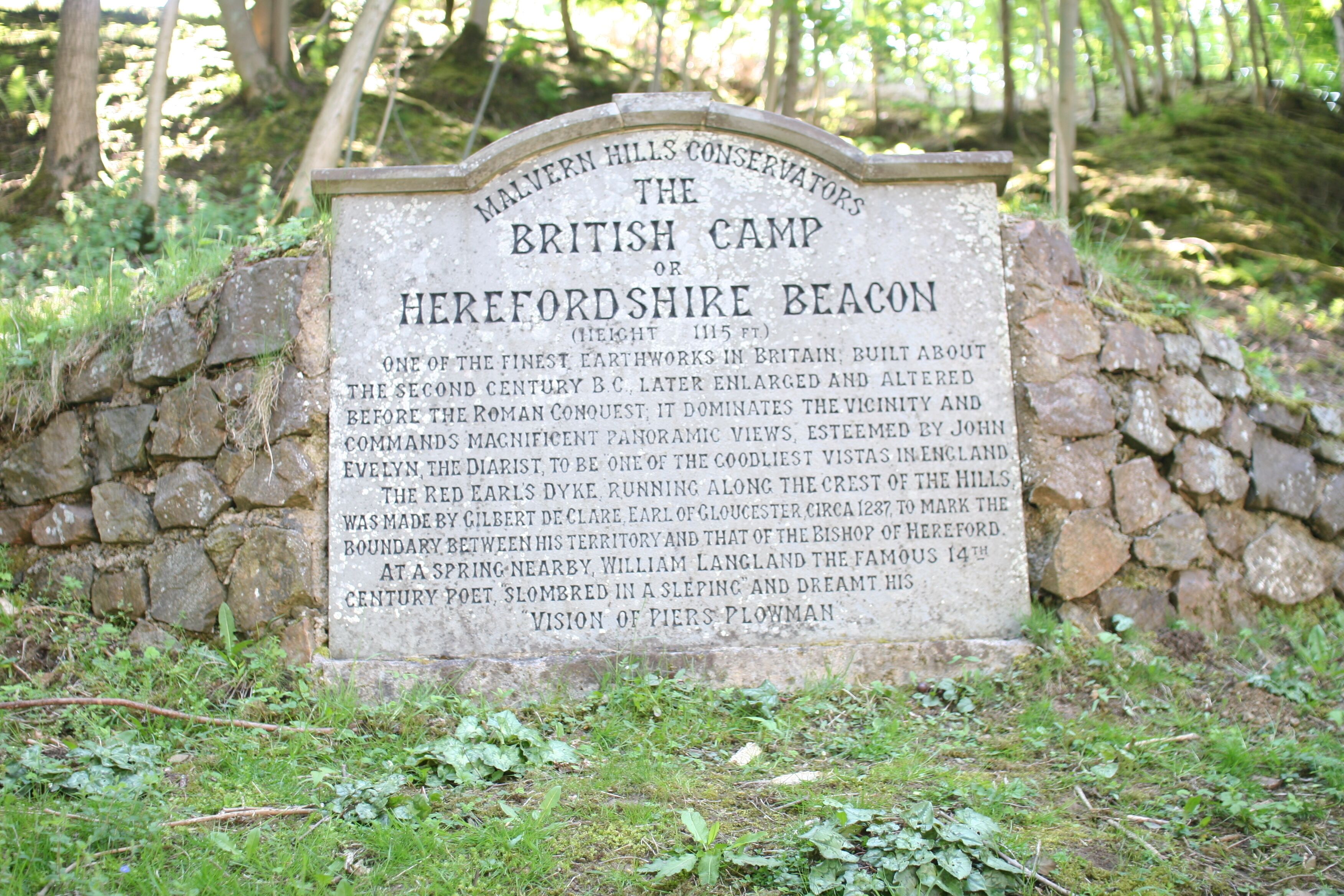 A stone sign with historical information about the British Camp in Herefordshire.