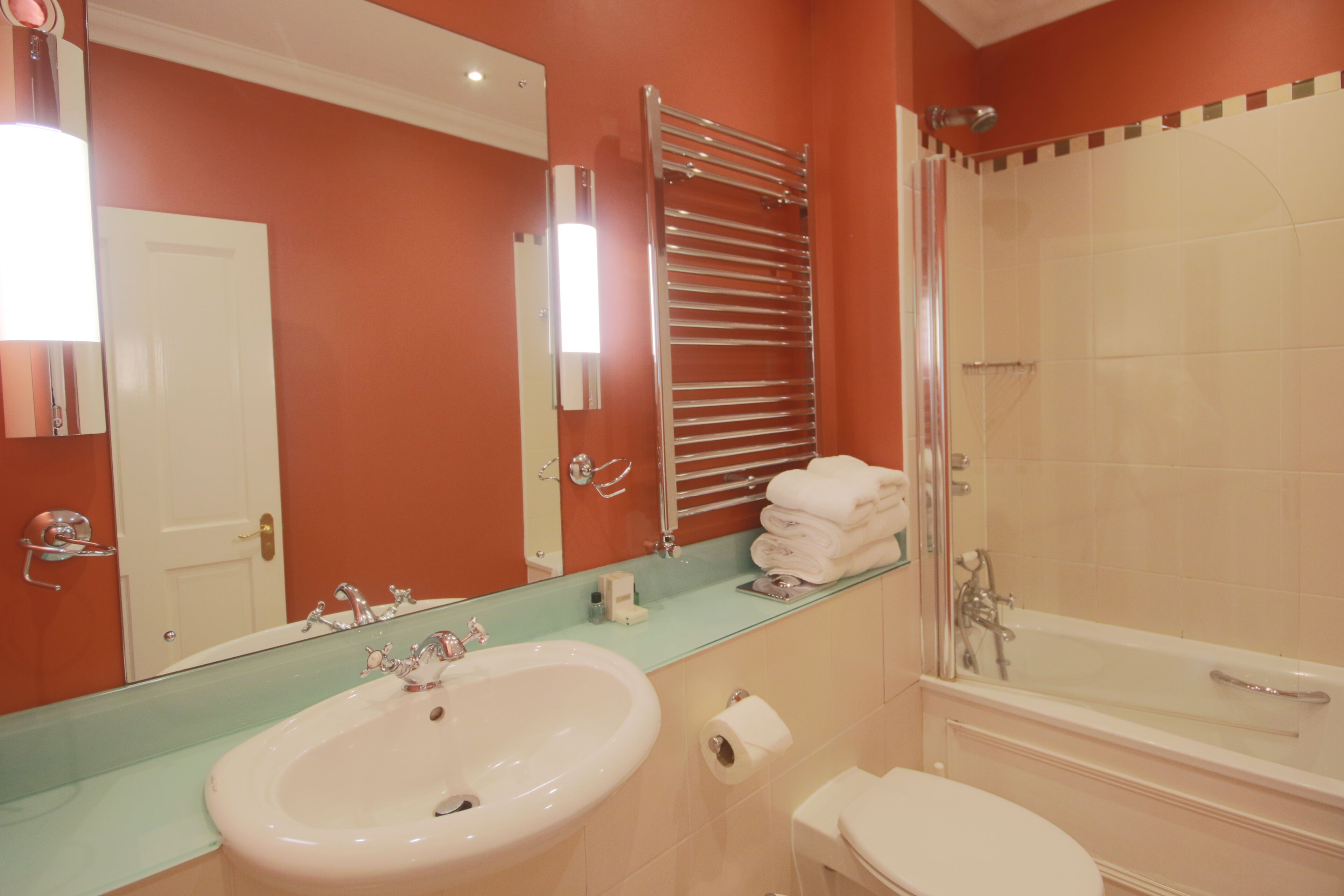 A bathroom with a sink, toilet, and shower.