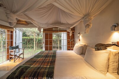 A unique, eco-friendly hideaway with walls that open to the savannah, allowing safari wildlife viewing from the comfort of the living room.