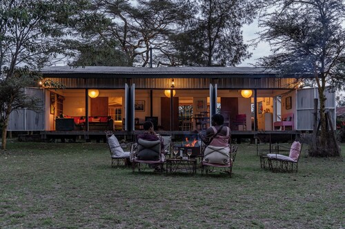 A unique, eco-friendly hideaway with walls that open to the savannah, allowing safari wildlife viewing from the comfort of the living room.