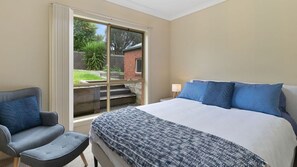 A bedroom with a bed, a chair, and a window. - Majestic Views (Marengo)