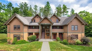 A two-story building with a central entrance, multiple windows, and a well-maintained lawn.