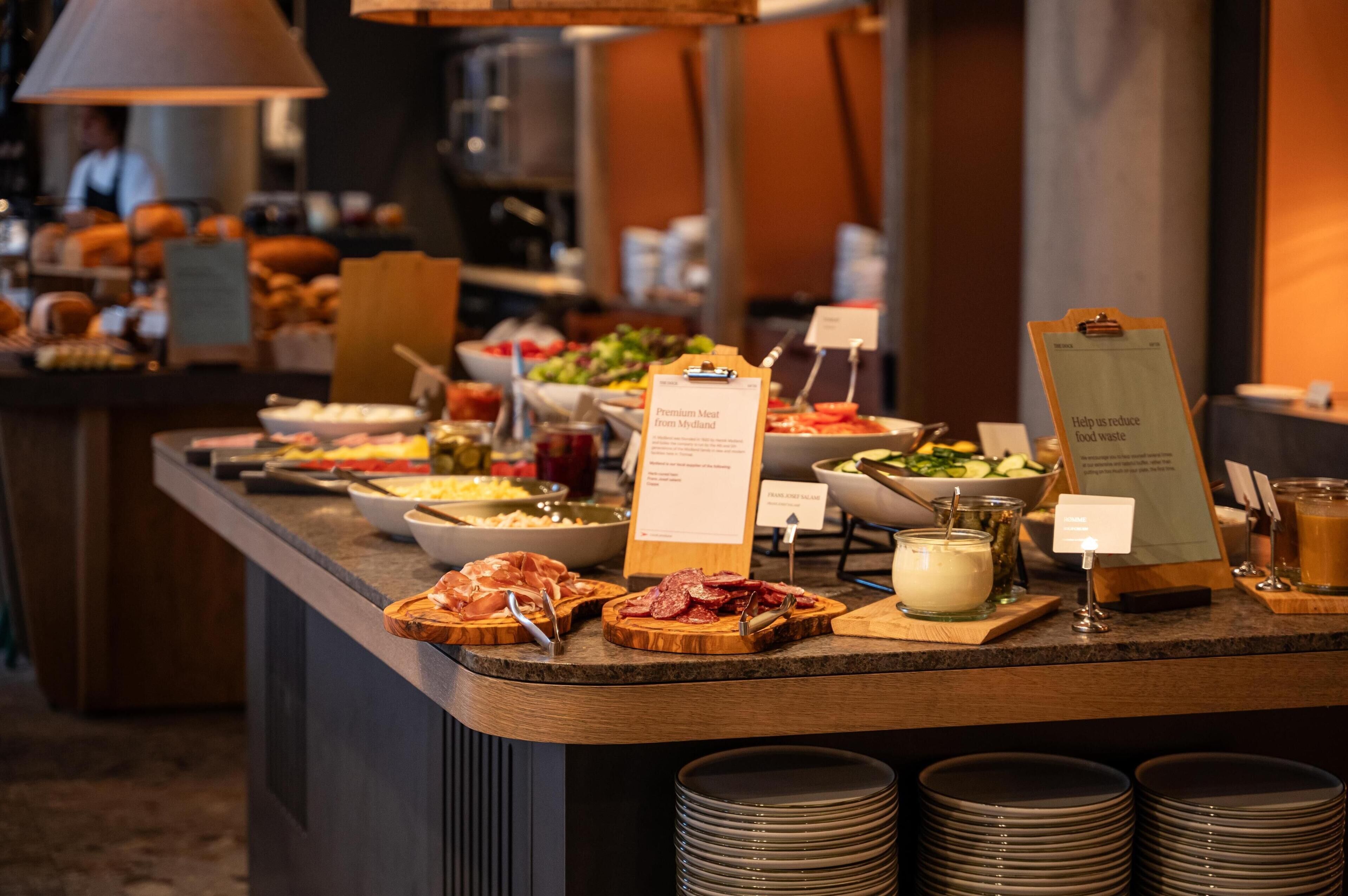 A buffet with various food options, including meats, salads, and beverages.