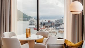 A modern room with a large window overlooking a marina and cityscape. - The Dock 69°39 by Scandic (Tromsø)