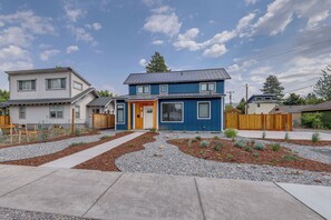 A two-story house with a blue exterior and a front yard with a gravel pathway and small plants. - Awesome Missoula Home w/ Patio < 2 Mi to Downtown! (Missoula)