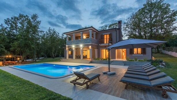 A modern two-story house with a swimming pool, outdoor seating, and a covered patio area. - Modern Villa Anima with swimming pool (Pazin)