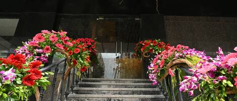 A staircase with floral decorations and a dark background.