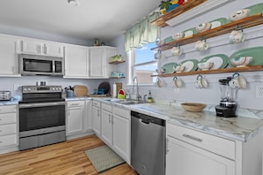 Enjoy cooking in this well-equipped kitchen with a dishwasher, oven, and microwave.