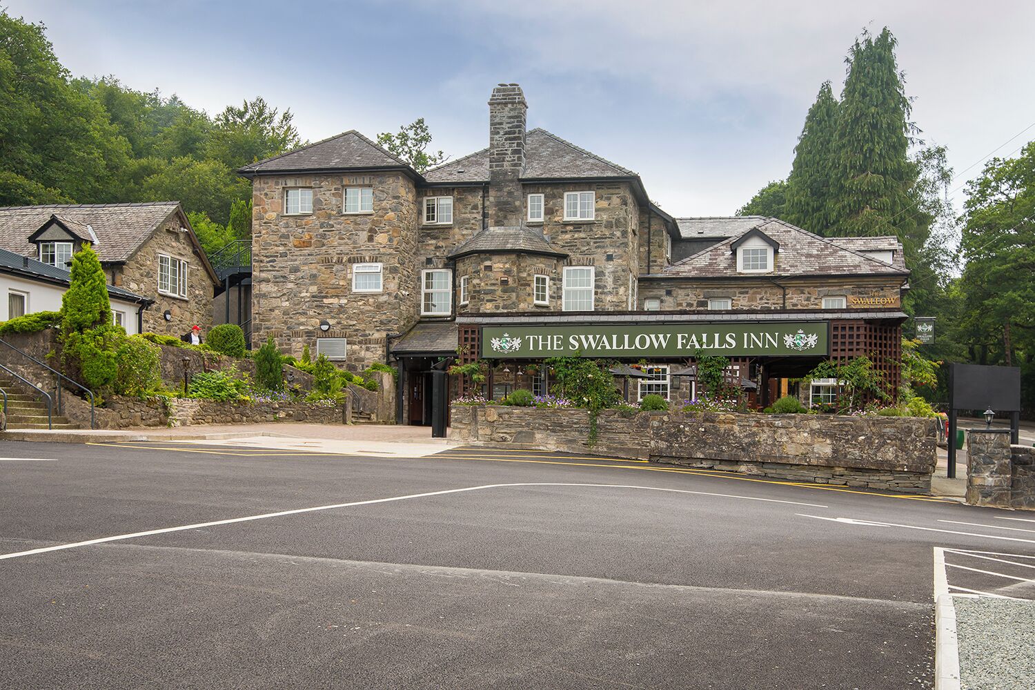 A stone building with a sign reading 'The Swallow Falls Inn'.
