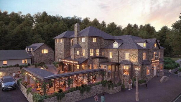 A stone building with multiple levels and a covered outdoor area with seating.