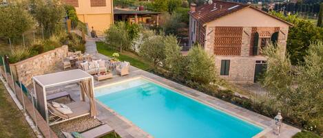 A private pool with outdoor seating and a stone wall.