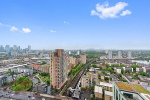 A high-rise building with multiple floors, surrounded by other buildings and roads. - Riverstone Heights (London)