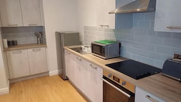 A kitchen with a microwave, oven, and toaster on the counter.