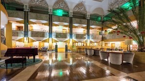 A spacious lobby with a grand staircase, marble flooring, and a central seating area. - Reignwood Pine Valley (Beijing)