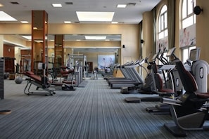 A gym with various exercise equipment, including treadmills and weight machines. - Reignwood Pine Valley (Beijing)