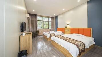 A modern hotel room with two beds, a desk, a television, and a window with curtains.