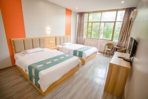 A hotel room with two beds, a desk, a chair, and a large window with curtains. - Yanyangtian Business Hotel (Yongzhou)
