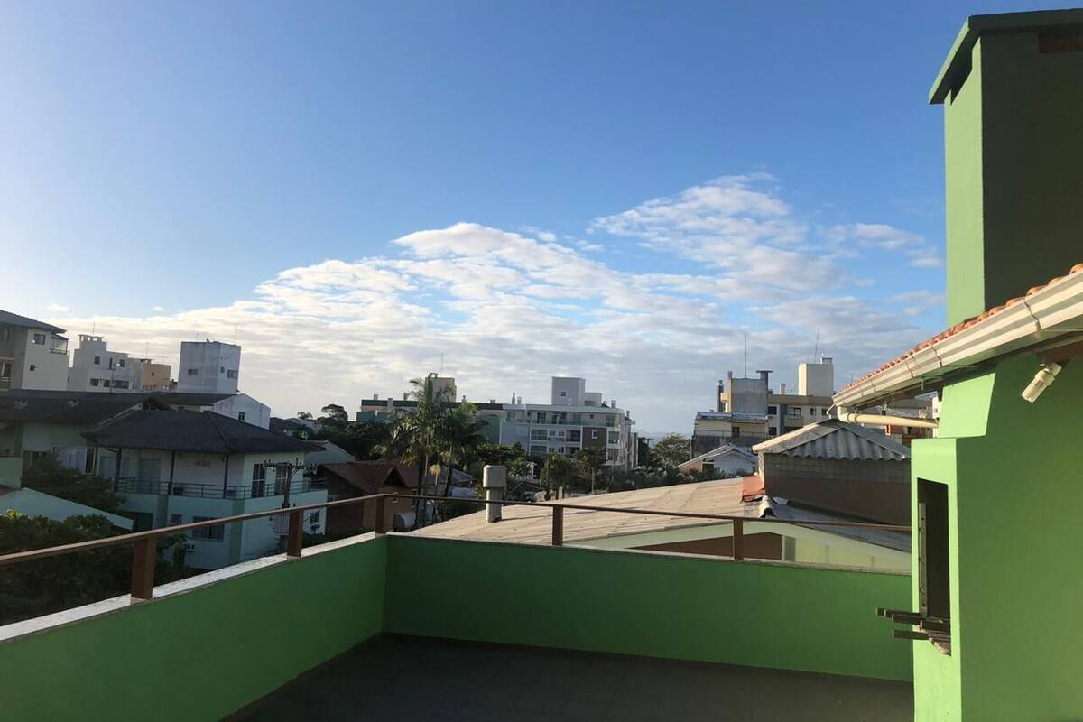 A rooftop terrace with a view of surrounding buildings.