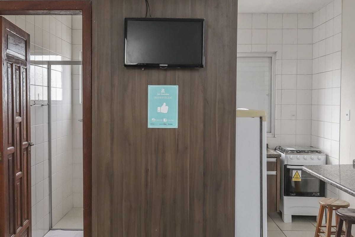 A kitchen with a built-in stove, a microwave, and a sink.