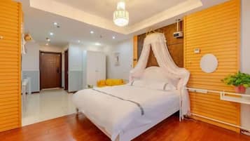 A bedroom with a canopy bed, wooden paneling, a ceiling light, and a small plant.