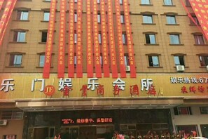 A hotel facade with multiple windows and a signboard with Chinese characters. - Wenzhou Jinfeng Business Hotel (Yongjia)
