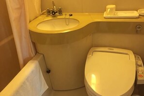 A bathroom with a sink, toilet, and a control panel. - Hotel Airway (Naha)