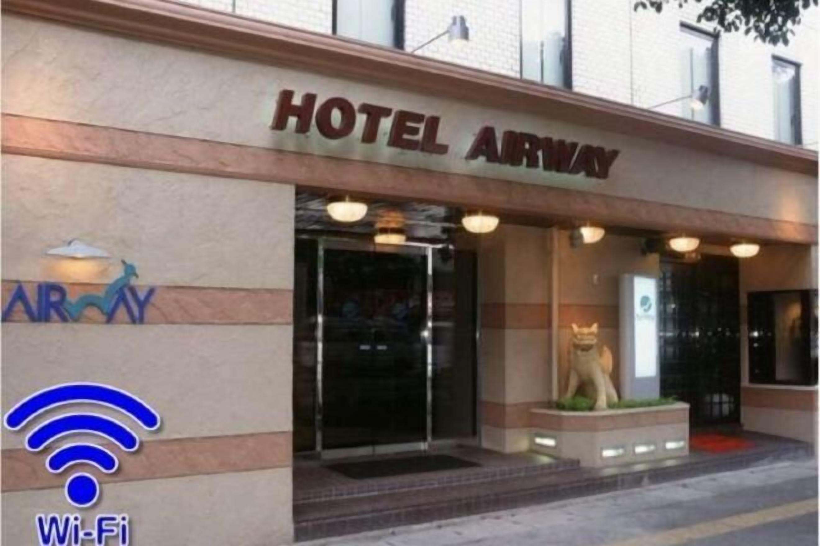 A hotel entrance with a sign reading 'HOTEL AIRWAY' and a Wi-Fi symbol.