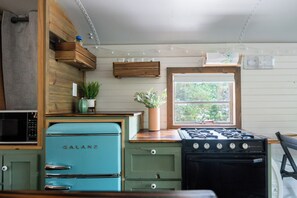 Fridge, microwave, coffee/tea maker, cookware/dishes/utensils