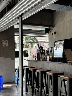 Enjoy a cup of coffee at our coffee bar, where a variety of drinks and condiments are available.