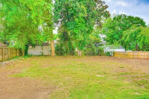 Surrounded by lush trees and a natural fence, this serene outdoor space offers a peaceful retreat.