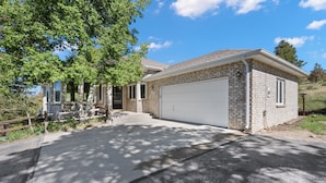 A single-story house with a garage, a front porch, and a driveway.
