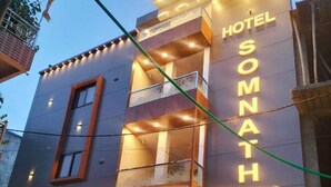 A modern hotel building with a prominent sign reading "Hotel Somnath Inn." - Hotel Somnath Inn (Ujjain)