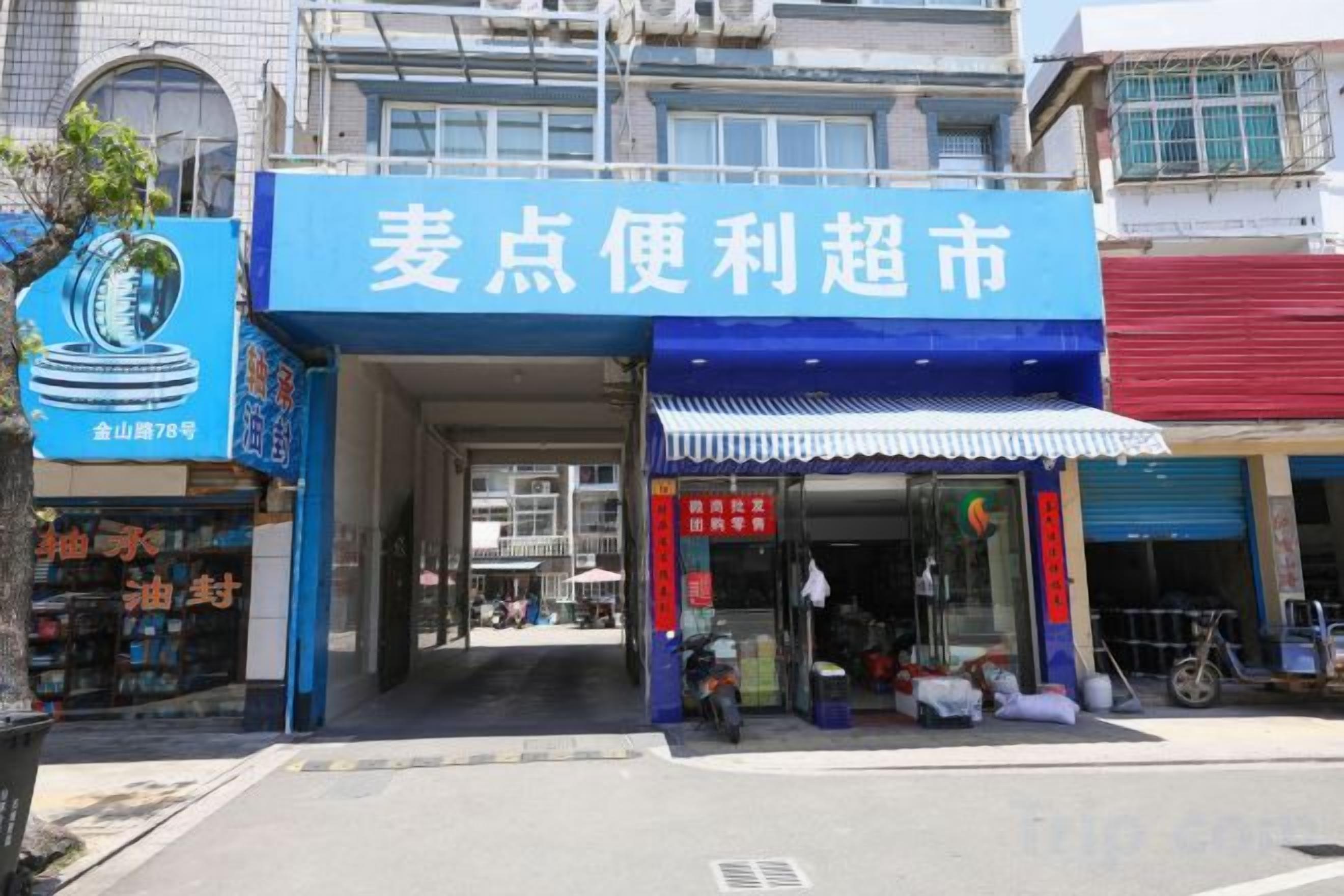 A storefront with a blue awning and a sign in a foreign script.