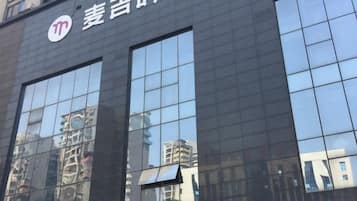 A building facade with large reflective windows and a logo.