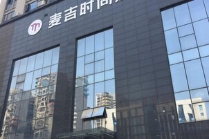 A building facade with large reflective windows and a logo.