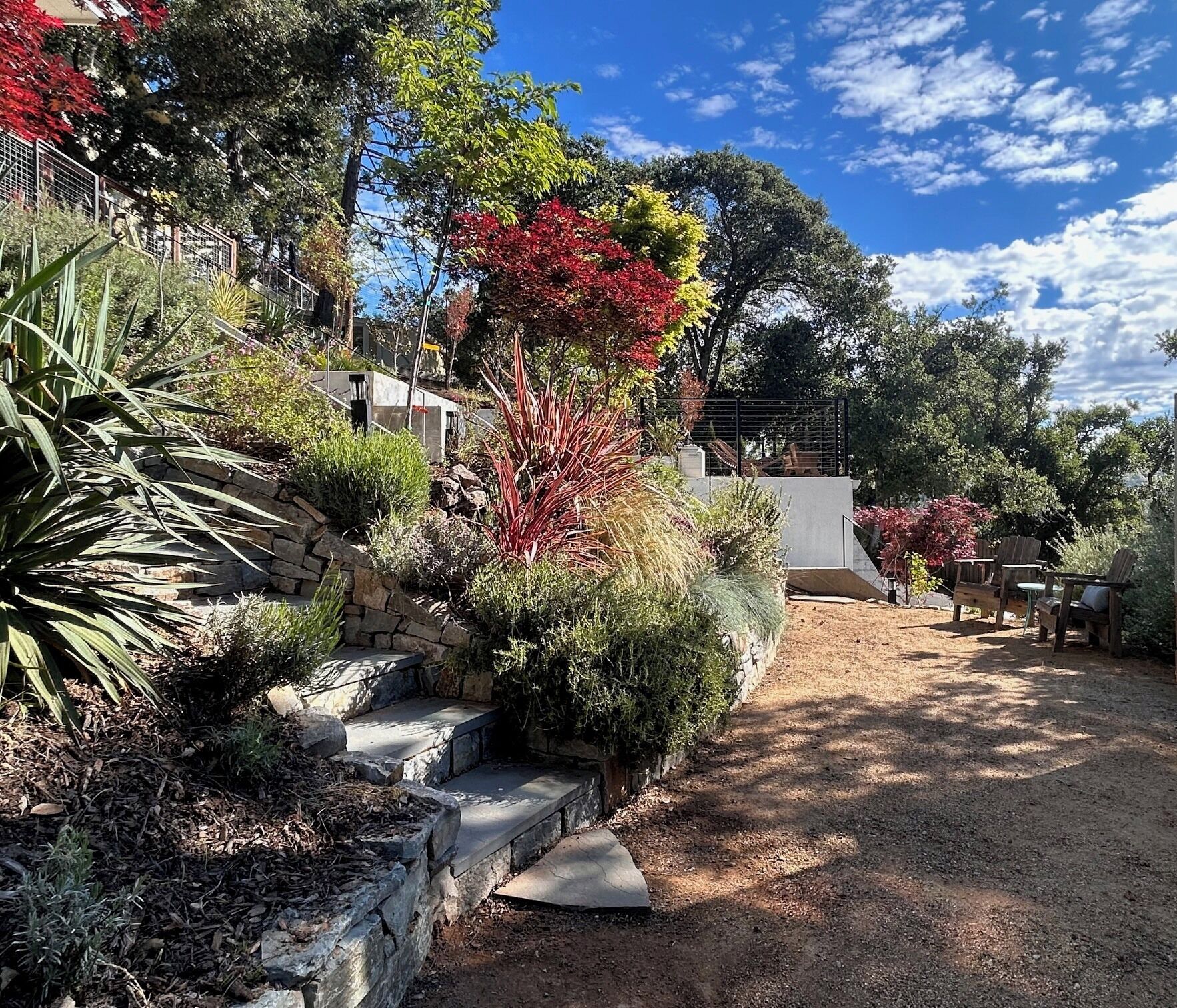stone steps from unit to decomposed granite hang out area with adirondack chairs