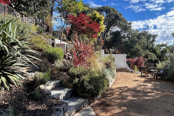 stone steps from unit to decomposed granite hang out area with adirondack chairs