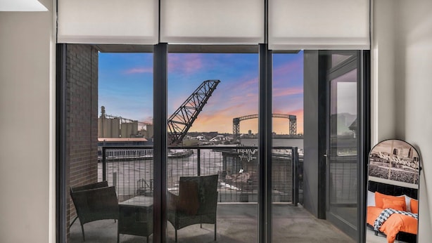 A balcony with a city view, including a bridge and buildings.