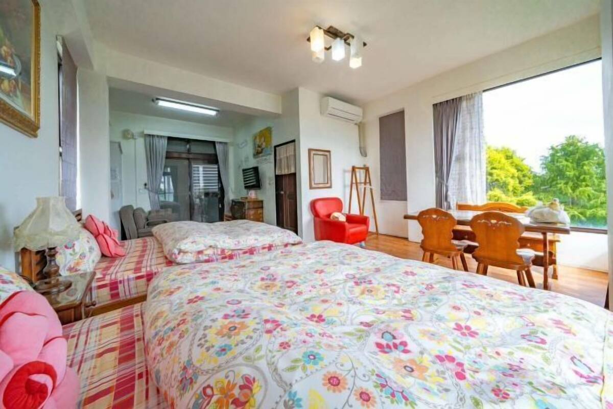 Un dormitorio con una cama grande, un escritorio y una silla.