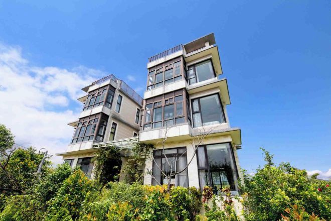 Un immeuble moderne à plusieurs étages, doté d’un toit plat et de grandes fenêtres.