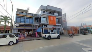 A multi-story building with a modern design, featuring balconies and large windows. - RedDoorz @ Bansud Oriental Mindoro (Bansud)