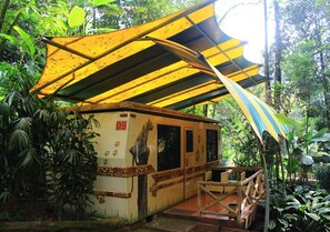 A small building with a leopard design, a covered outdoor area, and a wooden deck. - Safari Lodge Hotel (Cisarua)